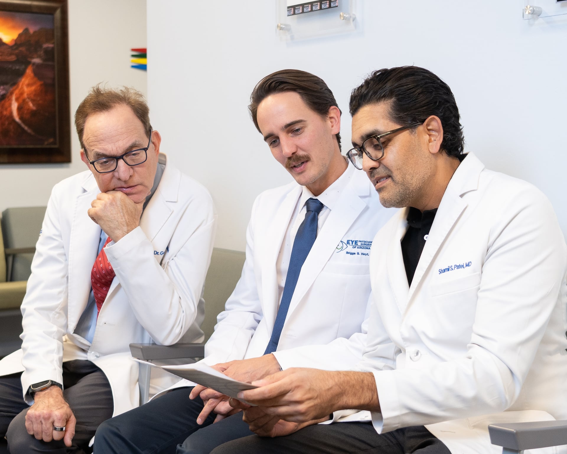 Dr. Reiss, Dr. Hoyt and Dr. Patel reviewing patient education materials